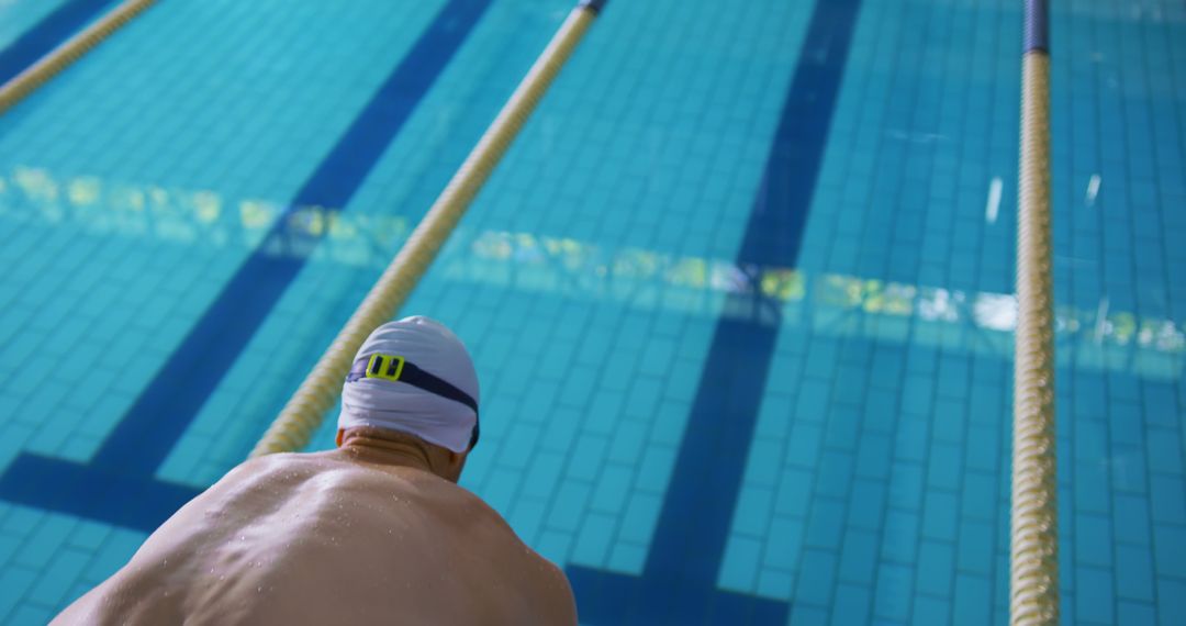 Professional Swimmer at Starting Block in Competitive Pool - Free Images, Stock Photos and Pictures on Pikwizard.com