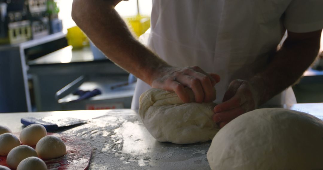 Professional Baker Kneading Dough in Modern Kitchen - Free Images, Stock Photos and Pictures on Pikwizard.com