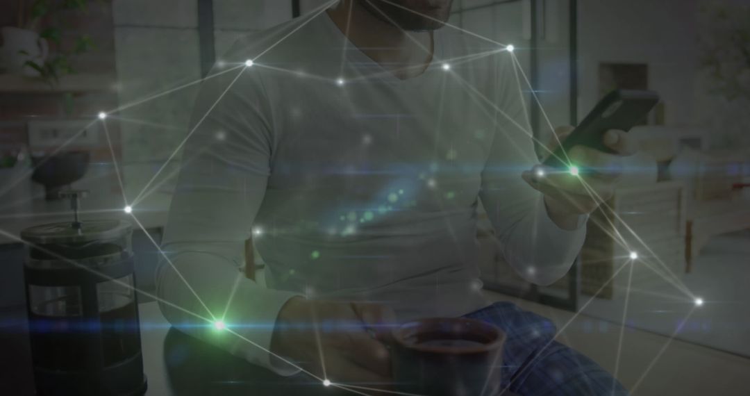 Man Using Smartphone and Drinking Coffee in Modern Room