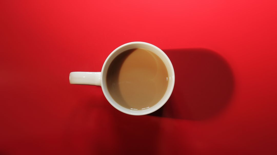 Top View of White Mug with Coffee on Bright Red Background - Free Images, Stock Photos and Pictures on Pikwizard.com