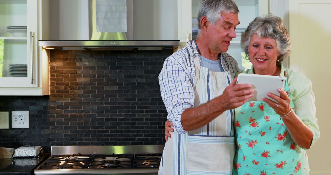 Senior Couple in Kitchen Using Tablet - Free Images, Stock Photos and Pictures on Pikwizard.com