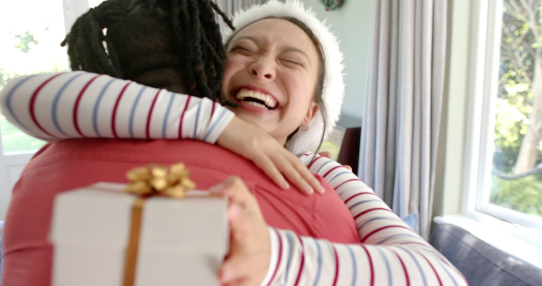 Joyful Woman Hugging Friend with Holiday Gift - Free Images, Stock Photos and Pictures on Pikwizard.com