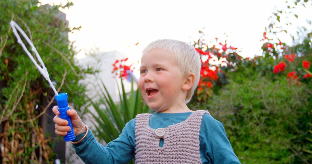 Smiling Boy Blowing Bubbles in Vibrant Garden