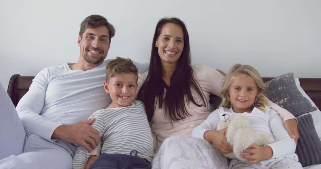 Happy Family Smiling on Couch Together - Free Images, Stock Photos and Pictures on Pikwizard.com