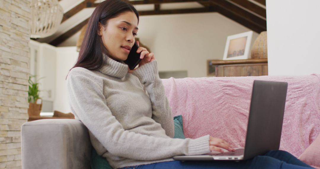 Woman Working Remote Using Laptop and Phone in Cozy Home - Free Images, Stock Photos and Pictures on Pikwizard.com