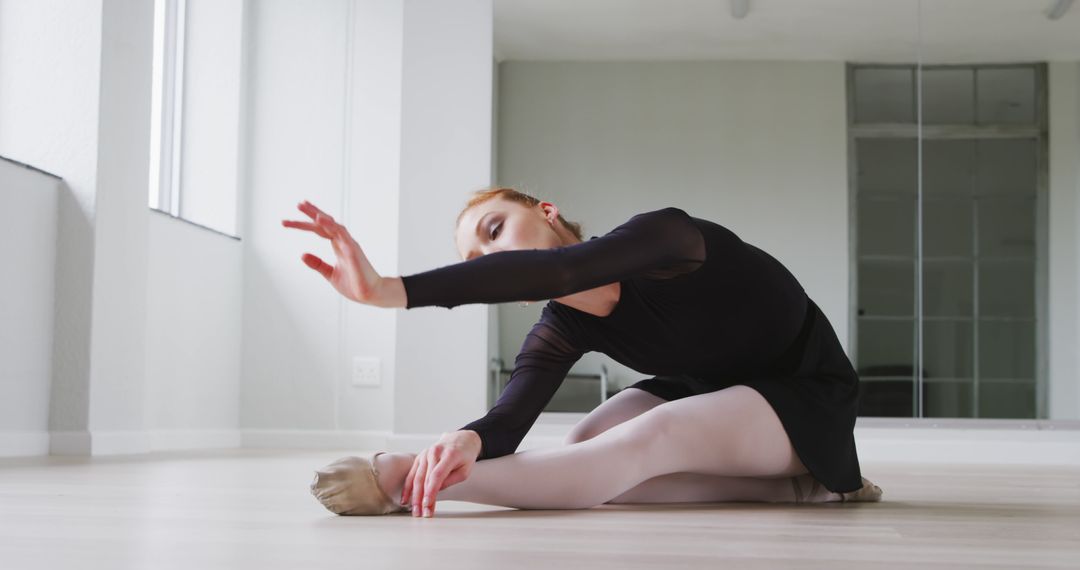 Young Ballerina Stretching in Dance Studio - Free Images, Stock Photos and Pictures on Pikwizard.com