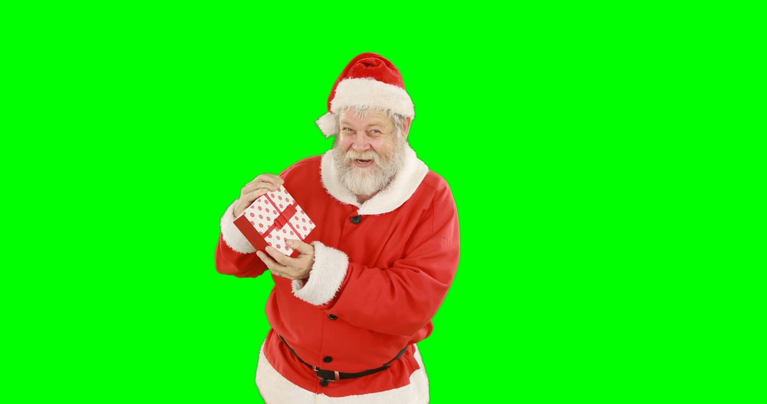 Santa Claus Holding Christmas Gift Against Green Screen - Free Images, Stock Photos and Pictures on Pikwizard.com