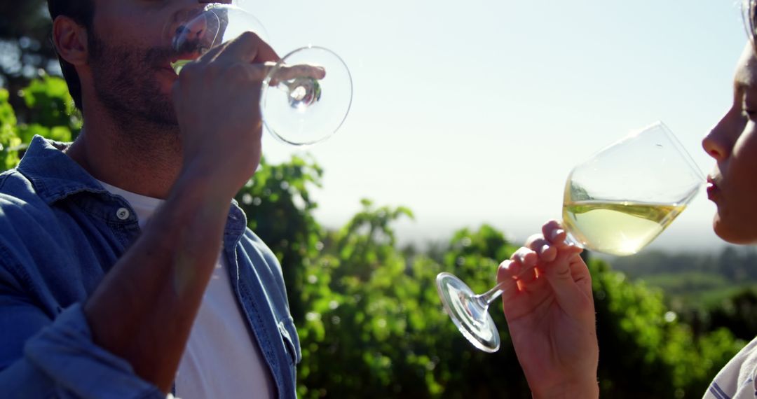 Couple Relishing Wine in Sunlit Vineyard