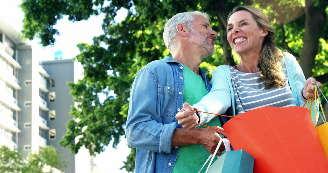 Joyful Senior Couple Shopping Outdoors on Sunny Day - Free Images, Stock Photos and Pictures on Pikwizard.com