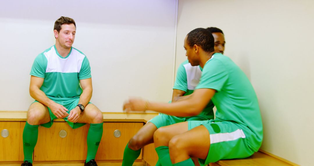 Teammates in Green Jerseys Sitting in Locker Room Bench - Free Images, Stock Photos and Pictures on Pikwizard.com