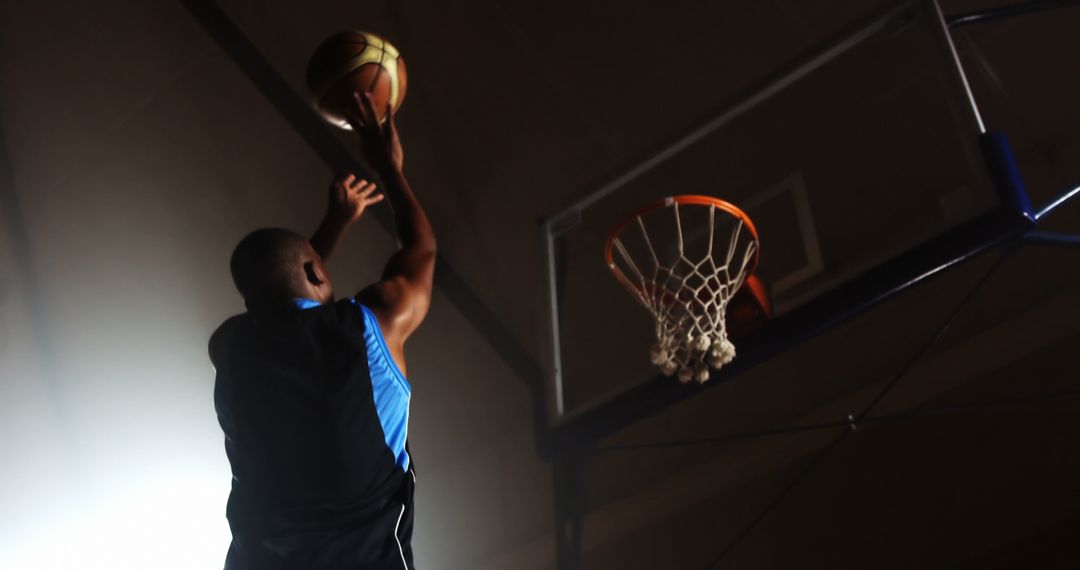 Basketball Player Scoring Basket in Indoor Court Game - Free Images, Stock Photos and Pictures on Pikwizard.com