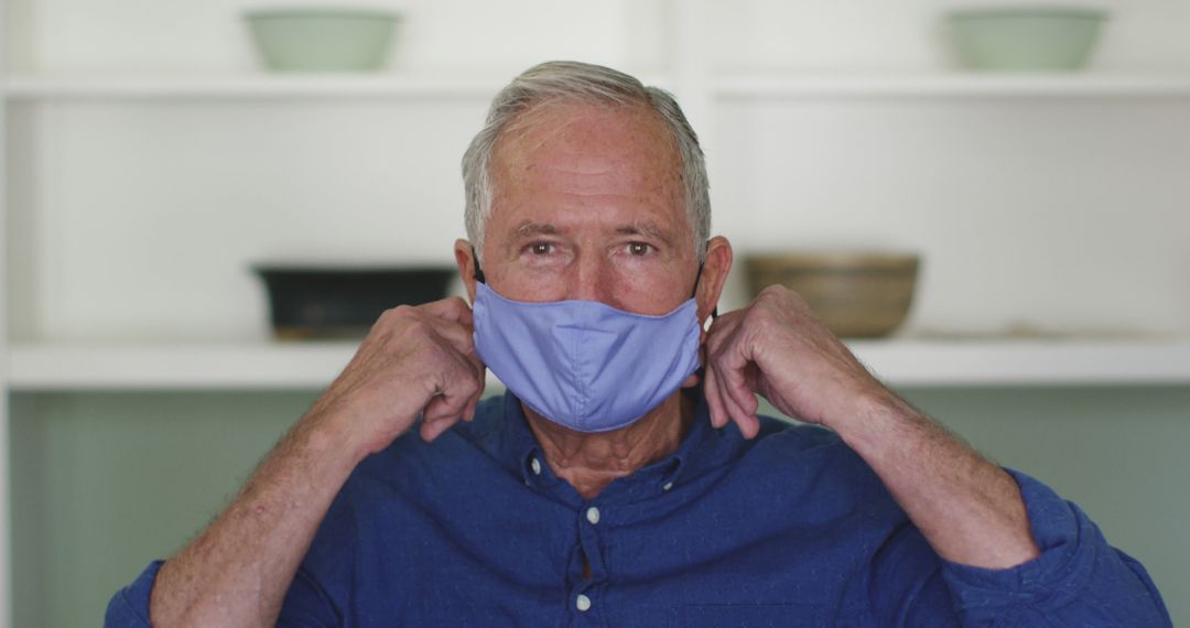 Elderly Man Adjusting Face Mask for Safety During Pandemic - Free Images, Stock Photos and Pictures on Pikwizard.com