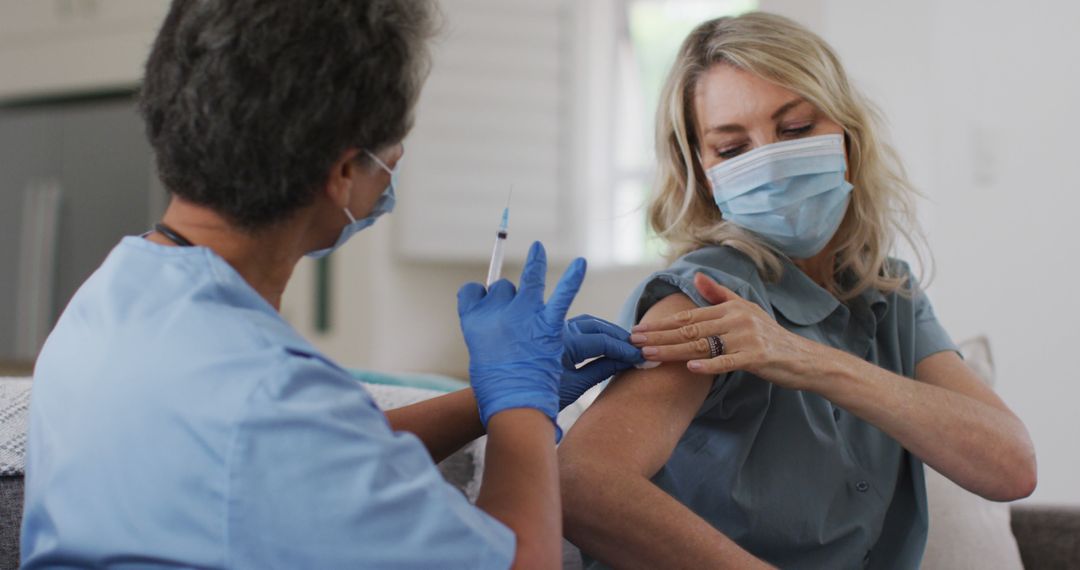 Healthcare Worker Administering Vaccine to Elderly Woman - Free Images, Stock Photos and Pictures on Pikwizard.com