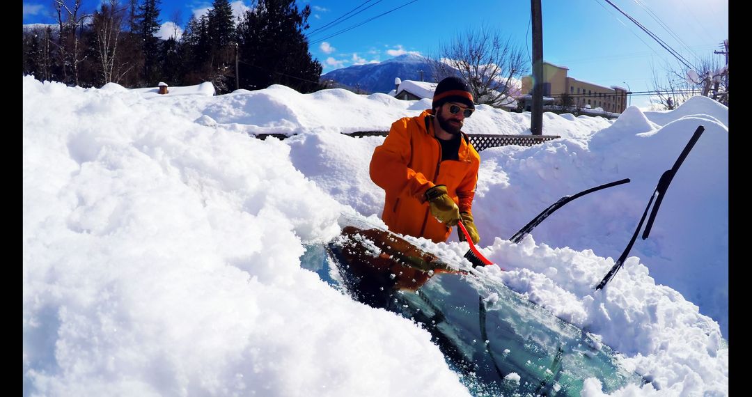 Man Clearing Heavy Snow from Car Windshield on Sunny Winter Day - Free Images, Stock Photos and Pictures on Pikwizard.com