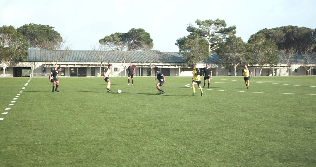 Boys Enthusiastically Playing Soccer on School Field