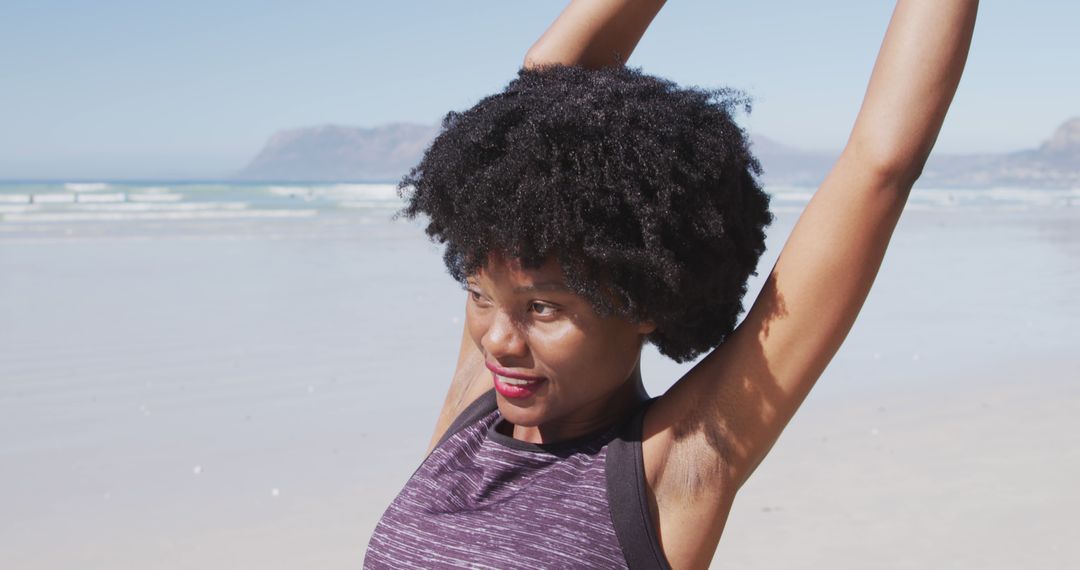 Woman Stretching on Sunny Beach with Scenic Ocean Background - Free Images, Stock Photos and Pictures on Pikwizard.com