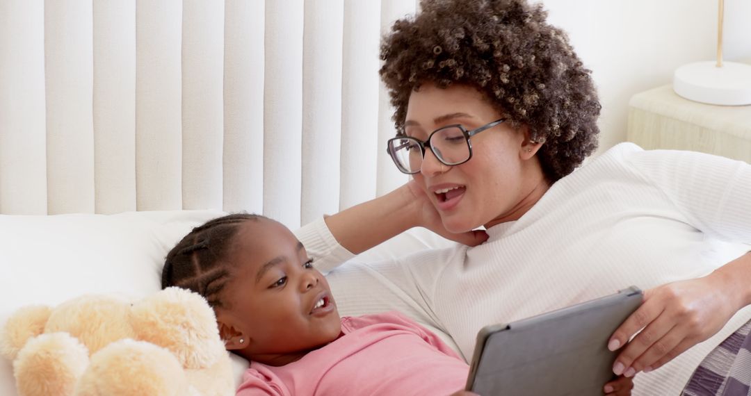 Mother and Daughter Bonding While Reading Tablet Together