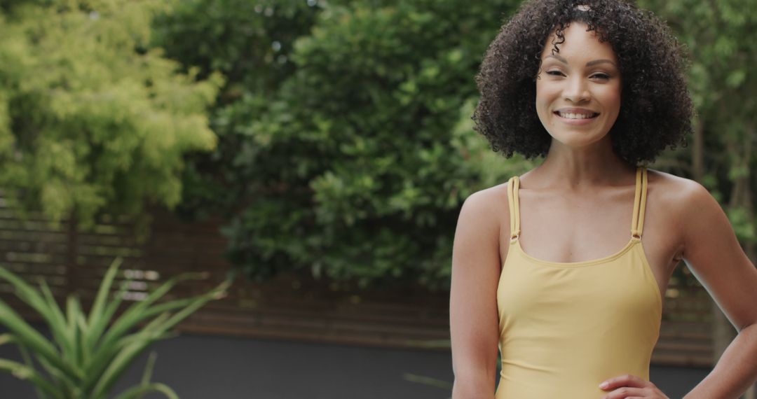 Smiling Woman in Yellow Tank Top Outside in Garden - Free Images, Stock Photos and Pictures on Pikwizard.com