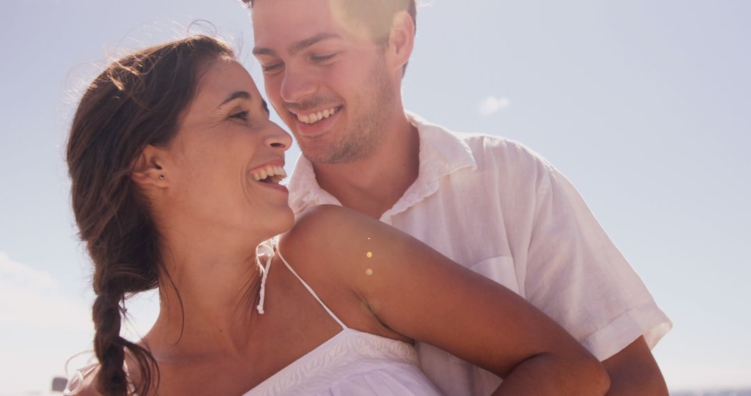 Joyful Couple Embracing Under Clear Sky With Copy Space