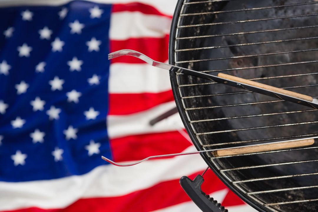 Barbecue Grill with Tongs and American Flag Background - Free Images, Stock Photos and Pictures on Pikwizard.com