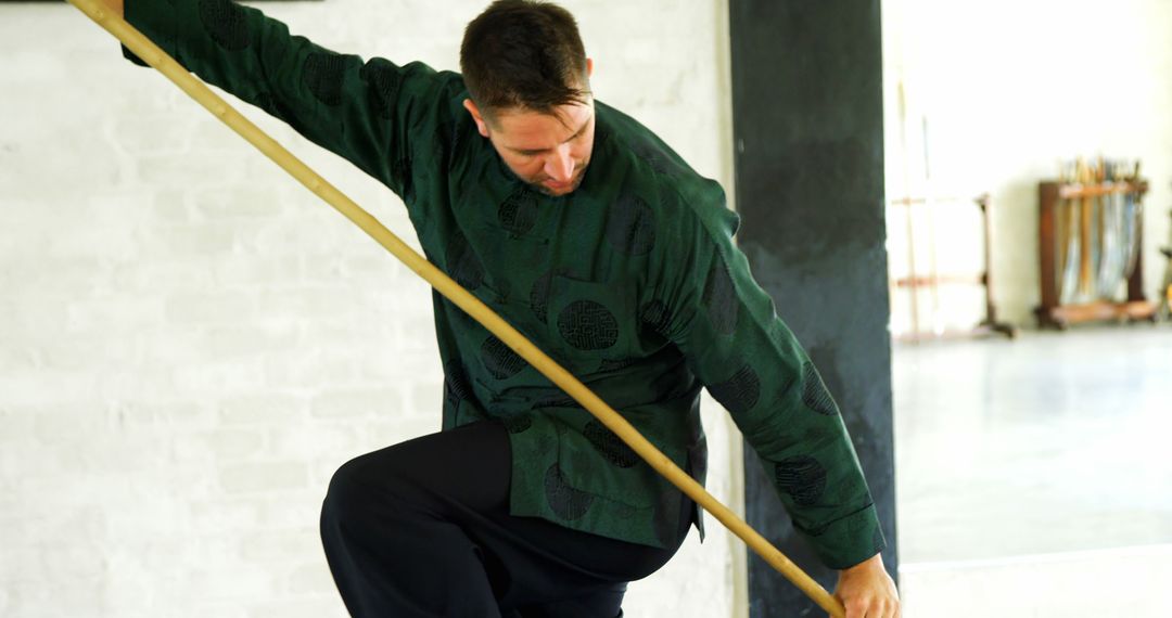 Man Practicing Martial Arts with Bo Staff in Traditional Uniform - Free Images, Stock Photos and Pictures on Pikwizard.com