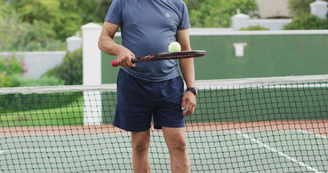 Senior Male Playing Tennis on Outdoor Court - Free Images, Stock Photos and Pictures on Pikwizard.com