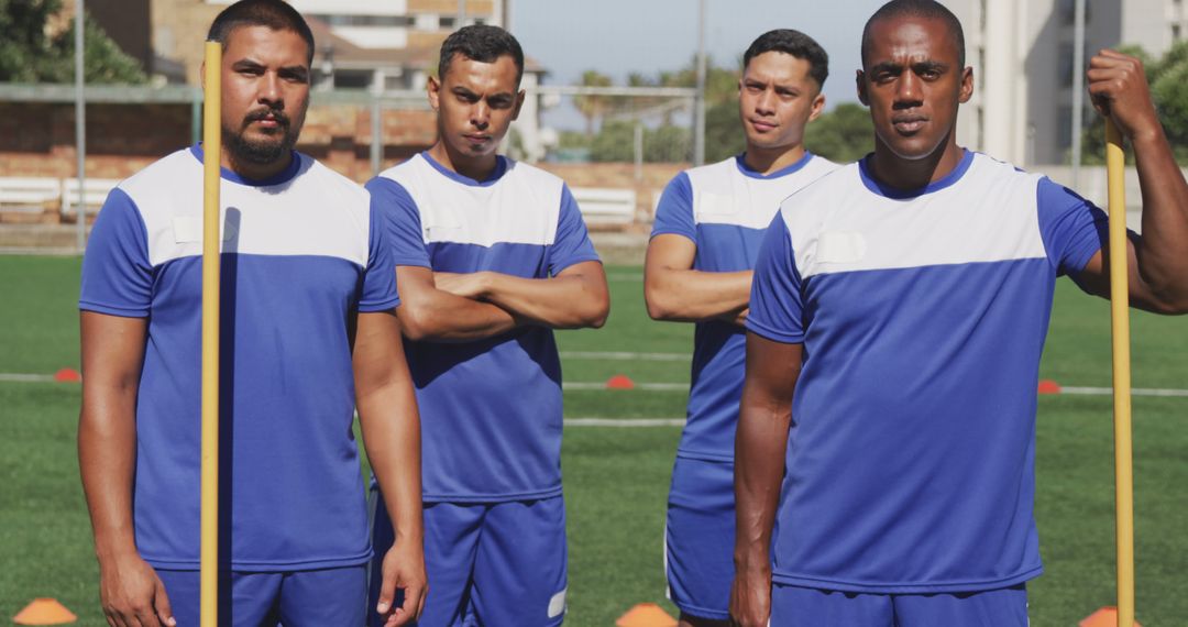 Portrait of diverse male football players wearing blue uniforms training on outdoor pitch - Free Images, Stock Photos and Pictures on Pikwizard.com