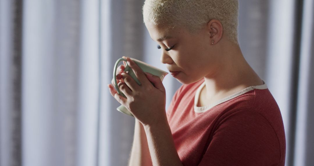 Contemplative Woman Enjoying Hot Beverage in Sunlit Room - Free Images, Stock Photos and Pictures on Pikwizard.com