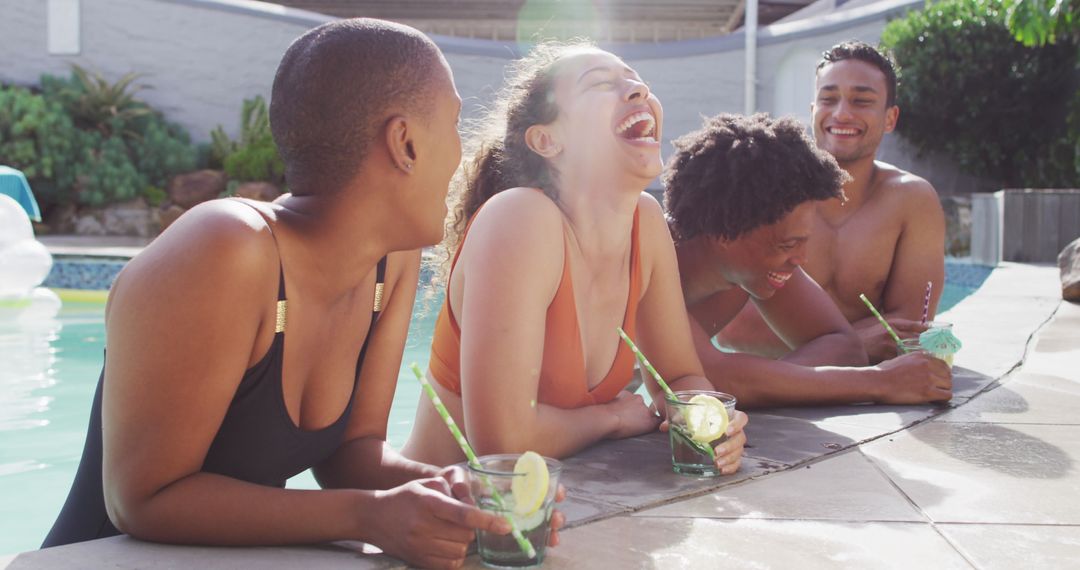 Diverse Friends Laughing Poolside with Drinks Enjoying Party