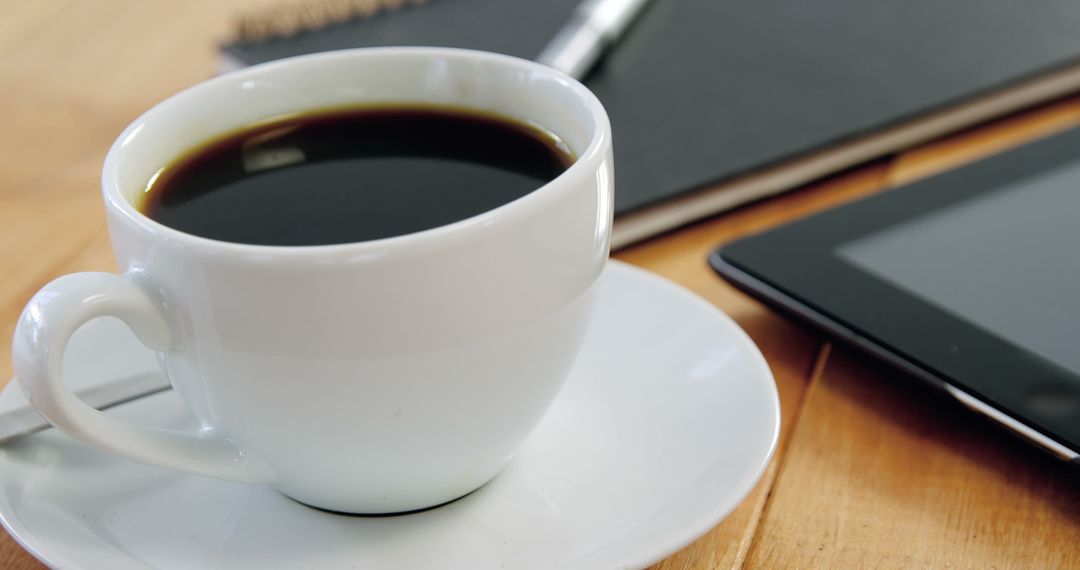 Coffee Cup on Wooden Table with Tablet and Notebook for Work - Free Images, Stock Photos and Pictures on Pikwizard.com