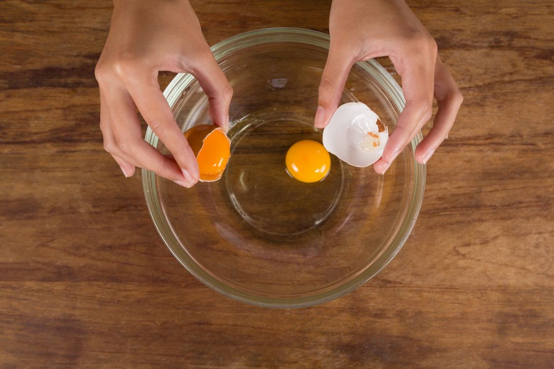 Man breaking eggs in bowl - Free Images, Stock Photos and Pictures on Pikwizard.com