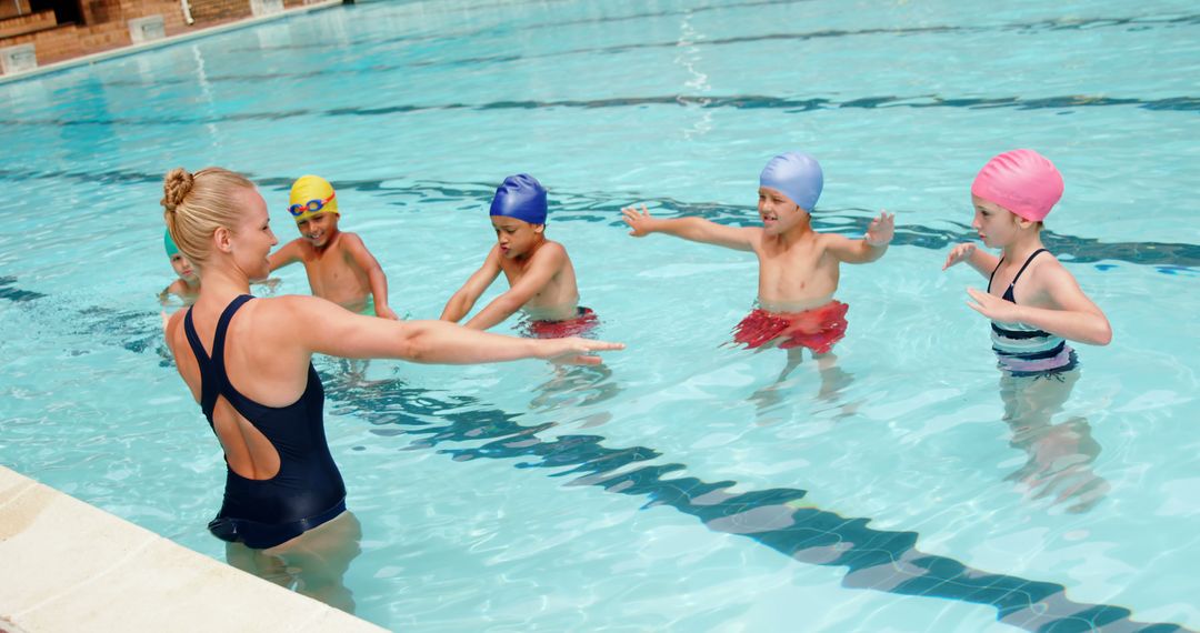 Swim Instructor Teaching Kids Arm Techniques in Pool - Free Images, Stock Photos and Pictures on Pikwizard.com