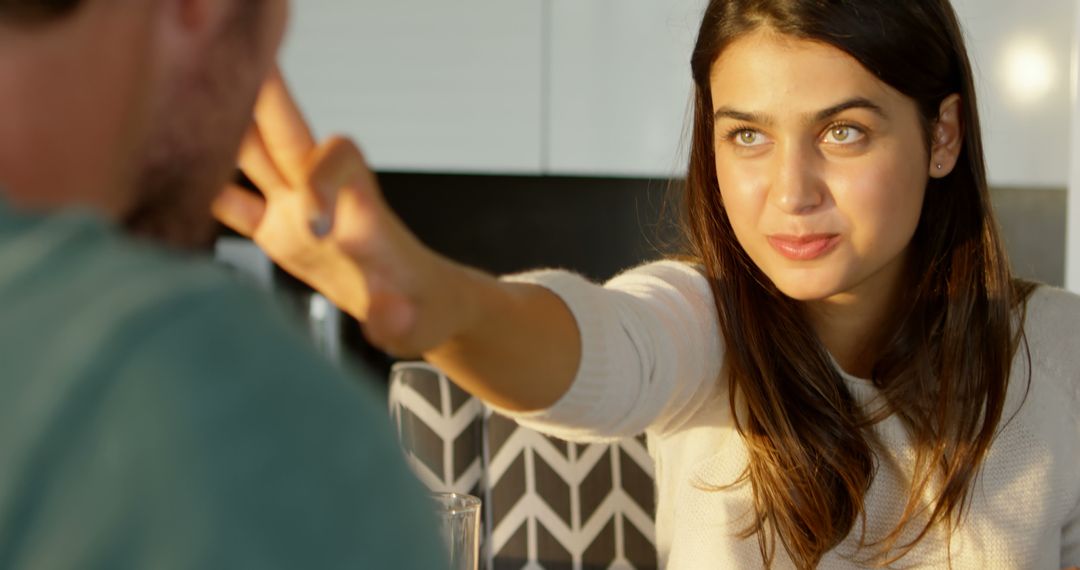 Young Woman Playfully Interacting with Man in Contemporary Home - Free Images, Stock Photos and Pictures on Pikwizard.com