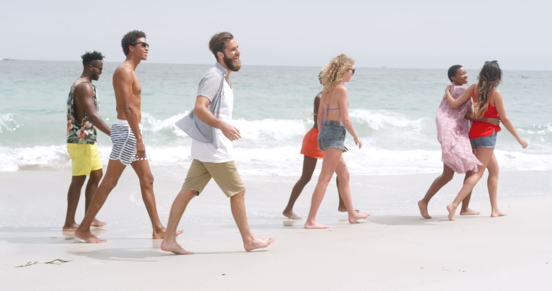 Friends Strolling on Sunny Beach in Summer Attire