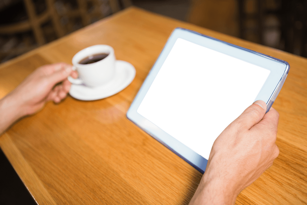 Hands Holding Transparent Tablet Next to Coffee