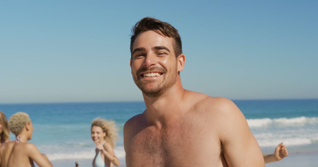 Smiling Man Enjoying Beach Day with Friends - Free Images, Stock Photos and Pictures on Pikwizard.com