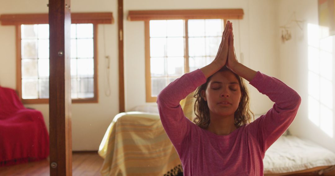 Woman Meditating with Calm Sunshine in Cozy Home Setting - Free Images, Stock Photos and Pictures on Pikwizard.com