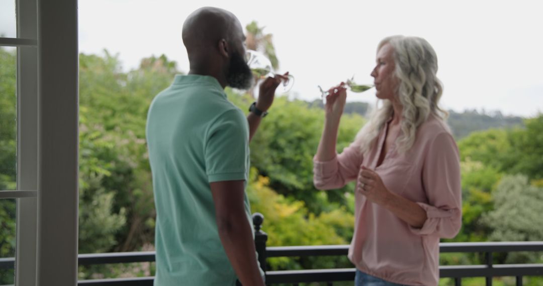 Couple Savoring Wine Together on Balcony with Scenic View
