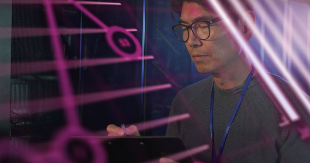 IT Technician Analyzing Network Data by Computer Server