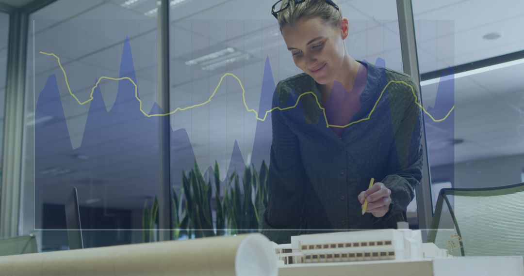 Businesswoman Analyzing Architectural Model with Data Overlay