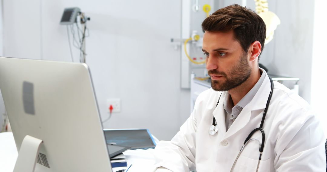 Focused Doctor Working on Computer in Modern Office - Free Images, Stock Photos and Pictures on Pikwizard.com