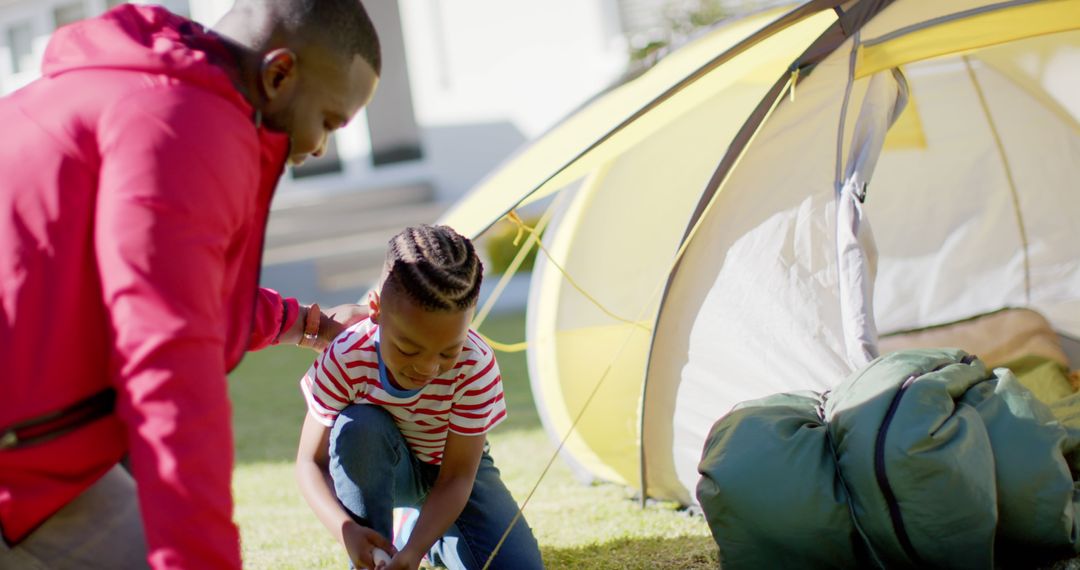 Father and Son Setting Up Tent Together Outdoors - Free Images, Stock Photos and Pictures on Pikwizard.com