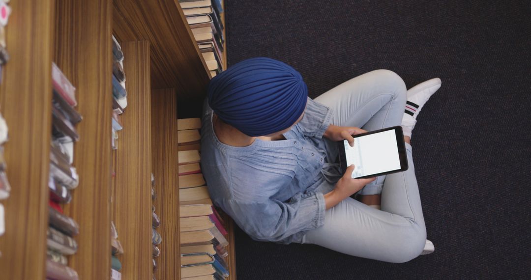 Muslim Woman Using Tablet in Library for Online Study - Free Images, Stock Photos and Pictures on Pikwizard.com