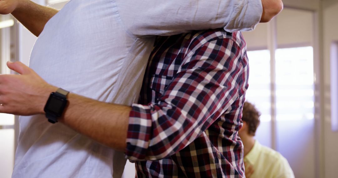 Two Men Hugging in Casual Clothes at Office - Free Images, Stock Photos and Pictures on Pikwizard.com