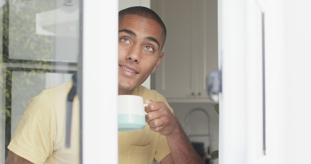 Man Smiling While Drinking Coffee at Home - Free Images, Stock Photos and Pictures on Pikwizard.com