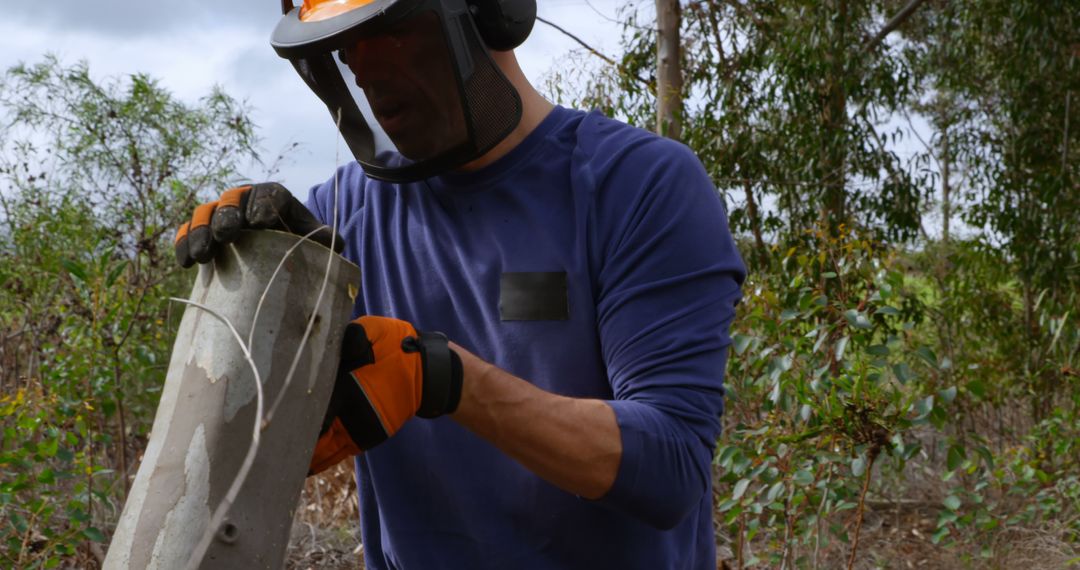 Forestry Worker Operating Chainsaw with Safety Gear in Action