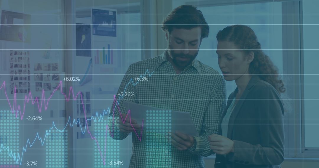 Office Colleagues Analyzing Financial Graphs and Reports