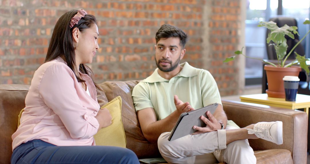 Colleagues Collaborating on Tablet in Modern Office Space
