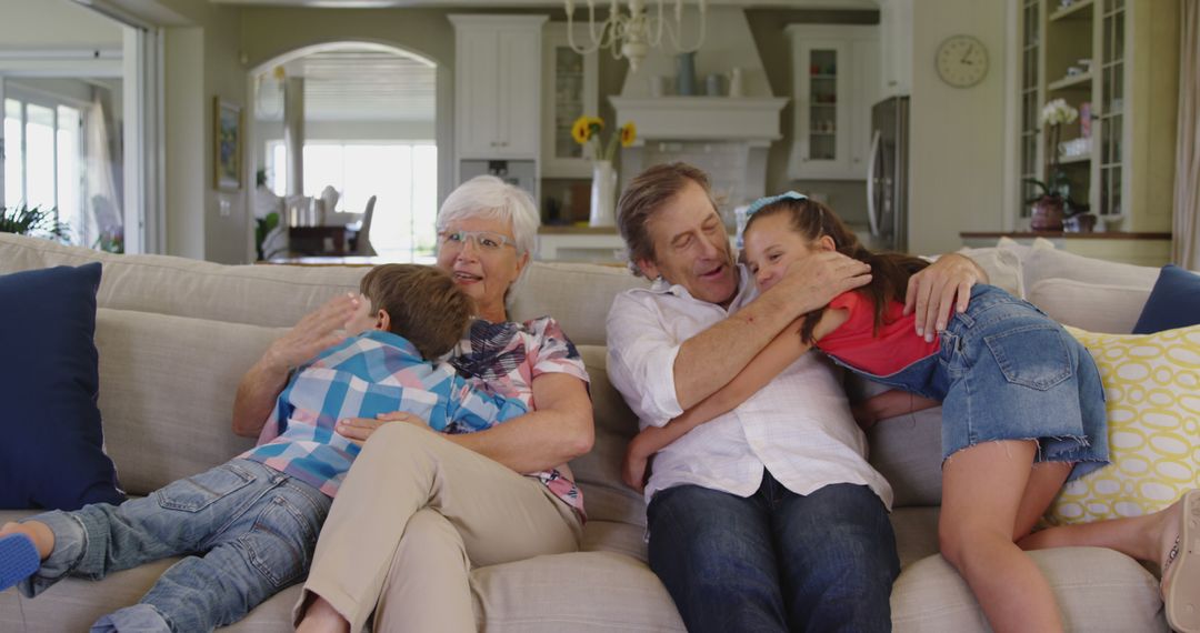 Grandparents Hugging Grandchildren in Living Room - Free Images, Stock Photos and Pictures on Pikwizard.com