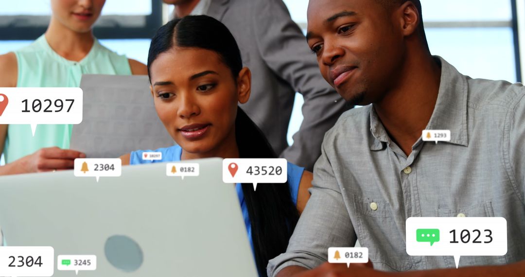 Diverse Colleagues Analyzing Data on Laptop with Virtual Notifications
